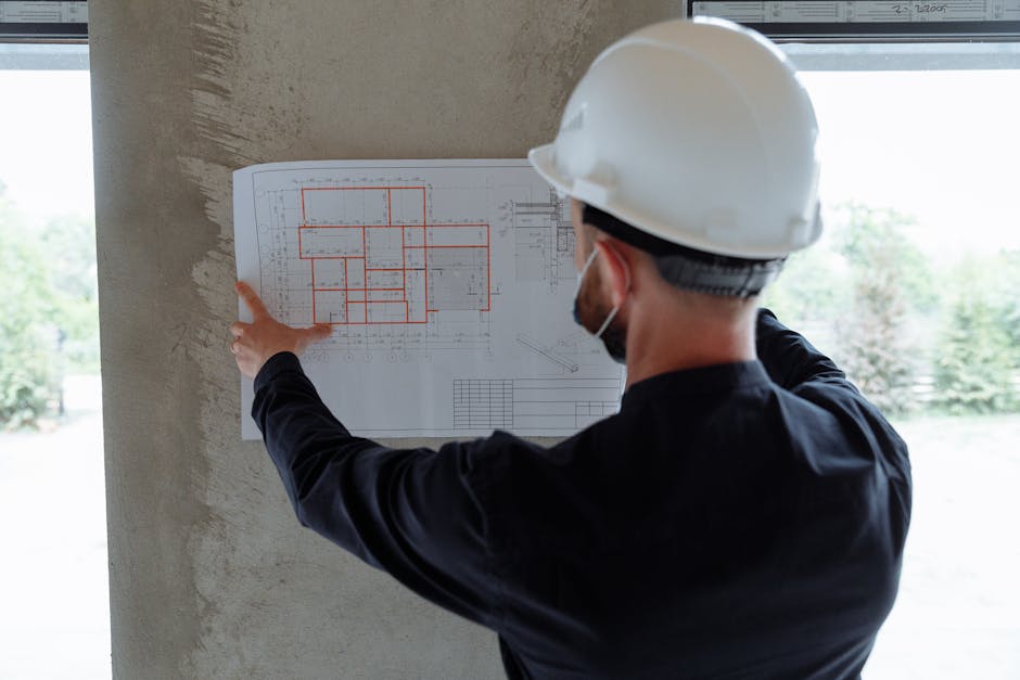 Structural engineer with hardhat and blueprints